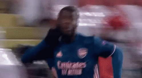 Blurry Soccer Player in Blue Emirates Shirt