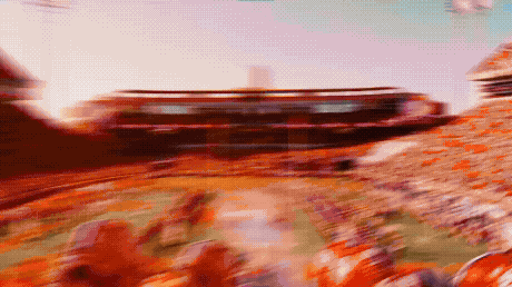Blurry Stadium With People in Orange Shirts