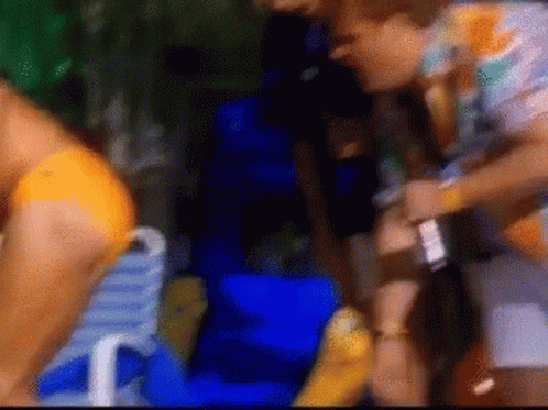 Blurry Woman In Bikini Sitting On Blue Chair
