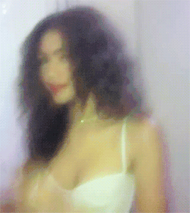 Blurry Woman In White Bra And Necklace GIF