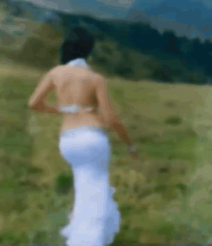 Blurry Woman in White Dress Walking in Field