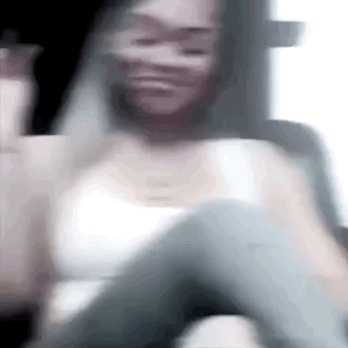 Blurry Woman In White Tank Top Sitting In Car GIF