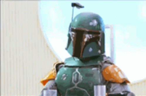 Boba Fett Is Standing In Front Of A Window Wearing A Helmet . GIF