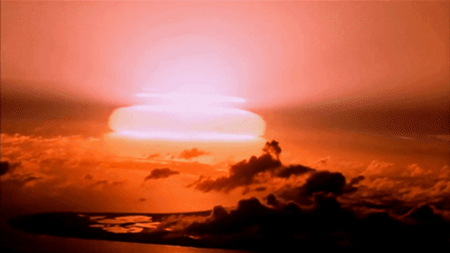 Bomb Explosion Illuminates The Horizon At Dusk GIF