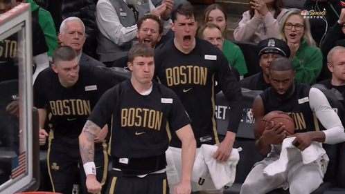 Boston Basketball Players Cheering in Front of Crowd