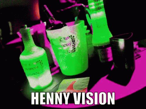 Bottle of Hennessy Next to Green Cup