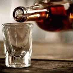 Bottle of Liquor Poured Into Shot Glass