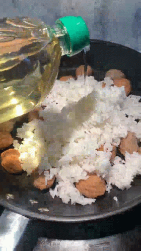 Bottle of Oil Poured Over Rice