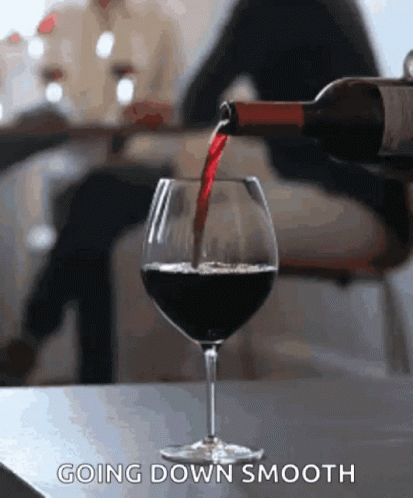 Bottle of Wine Being Poured Into Glass Going Down Smooth