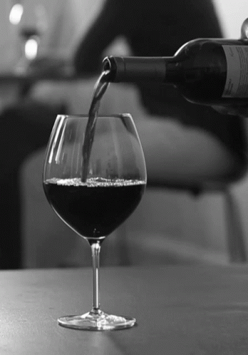 Bottle of Wine Poured Into Wine Glass