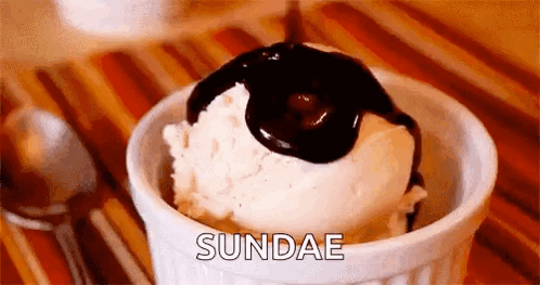 Bowl of Ice Cream With Chocolate Sauce Pouring