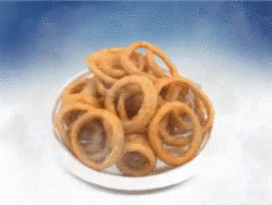 Bowl of Onion Rings on Blue Background