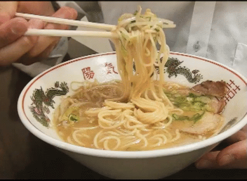 Bowl of Ramen With Chopsticks and Chinese Writing