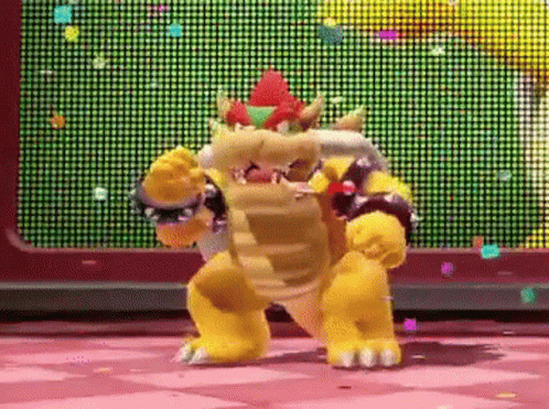 bowser is dancing in front of a screen with confetti falling from it .
