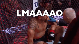 Boxer Kneeling In Ring Referee Examining Wound GIF