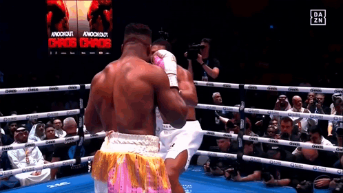 Boxers Fighting in Ring with Chaos Sign