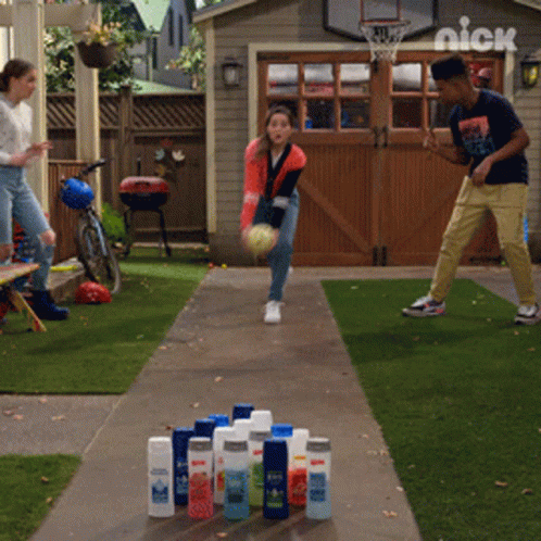 Boy and Girl Bowling in Front of Nick Basketball Hoop