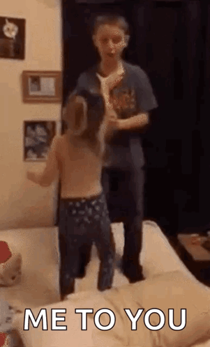 Boy And Girl Jumping On Bed GIF