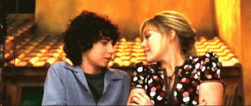 Boy and Girl Kissing in Restaurant