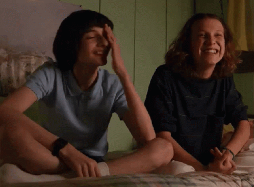 Boy and Girl Laughing on Bed