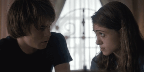 Boy And Girl Looking At Each Other By Window GIF
