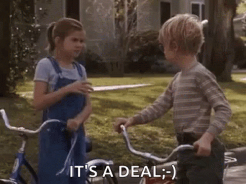 Boy And Girl Shaking Hands On Bicycles GIF