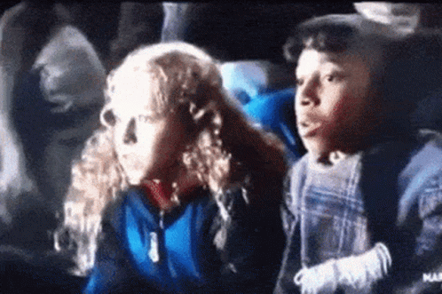 Boy And Girl Sitting In Theater Watching Movie GIF