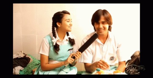 Boy and Girl Sitting With Microphone