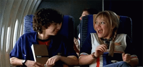 Boy and Girl Talking on Airplane