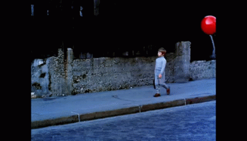 Boy and Girl Walking With Balloons