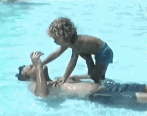 Boy and Man Playing in Pool