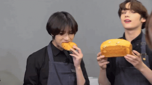 Boy Eating Bread While Another Holds Loaf GIF