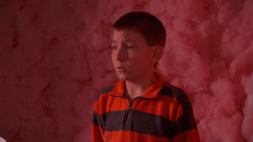 Boy Eating Pink Cotton Candy in Front of Pink Wall