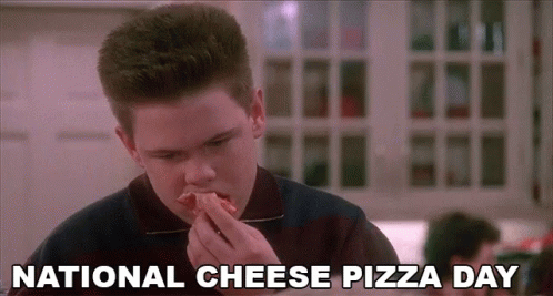 Boy Eating Pizza in Restaurant