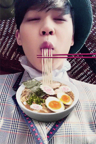 Boy Eating Ramen With Chopsticks and Eggs