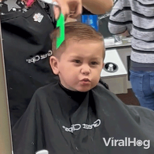 Boy Getting Haircut From Barber in Classic Clips Apron