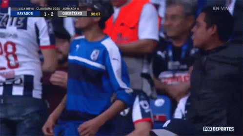 Boy in Blue and White Jersey in Soccer Stands