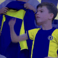 Boy in Blue and Yellow Shirt With Letter O