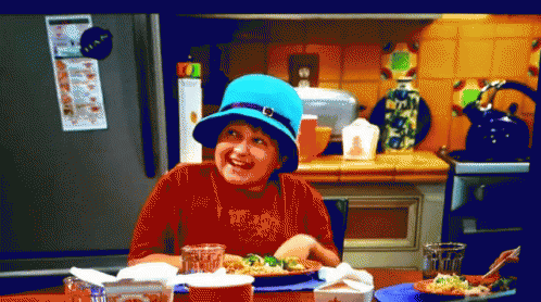 Boy In Blue Hat Sitting At Table With Food GIF