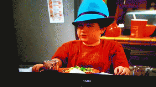 Boy In Blue Hat Sitting At Table With Vizio TV GIF