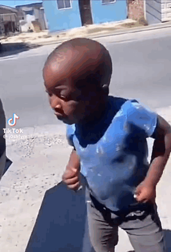 Boy in Blue Shirt Walking