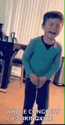 Boy in Blue Sweater Standing in Living Room
