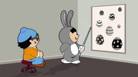 Boy In Bunny Costume Pointing At Eggs GIF