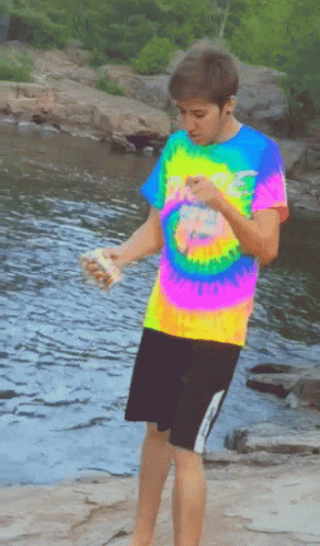 Boy In Colorful Tie-Dye Shirt By River GIF