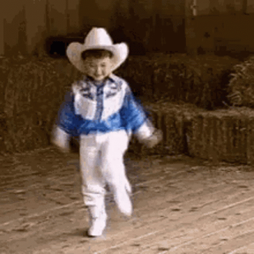 Boy in Cowboy Hat Walking on Wooden Floor