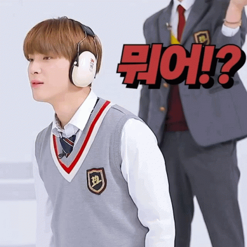 Boy in Ear Muffs Facing Man in Suit with Question Mark