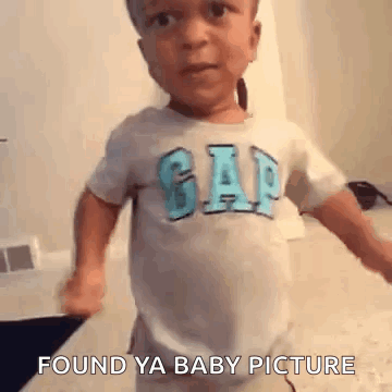 Boy in Gap Shirt Standing on Bed