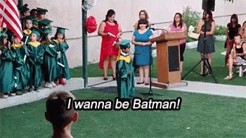 Boy in Graduation Cap and Gown Speaking