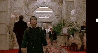 Boy in Green Coat Walking Down Red Carpet