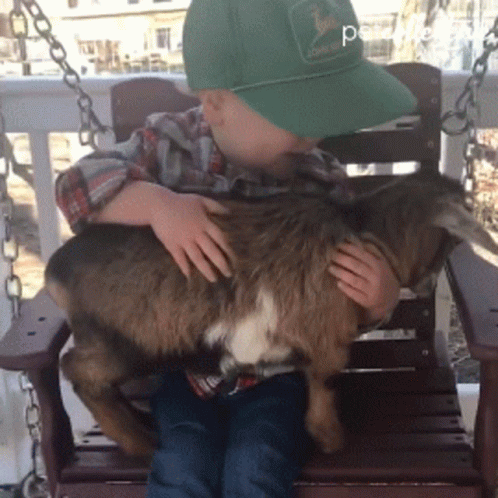 Boy in Green John Deere Hat Holding Goat